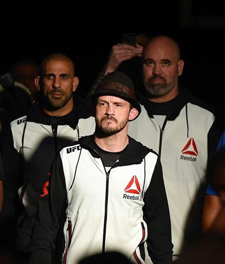 Dr. Gavoni walking out with UFC professional Brad Pickett, surrounded by corner staff and security